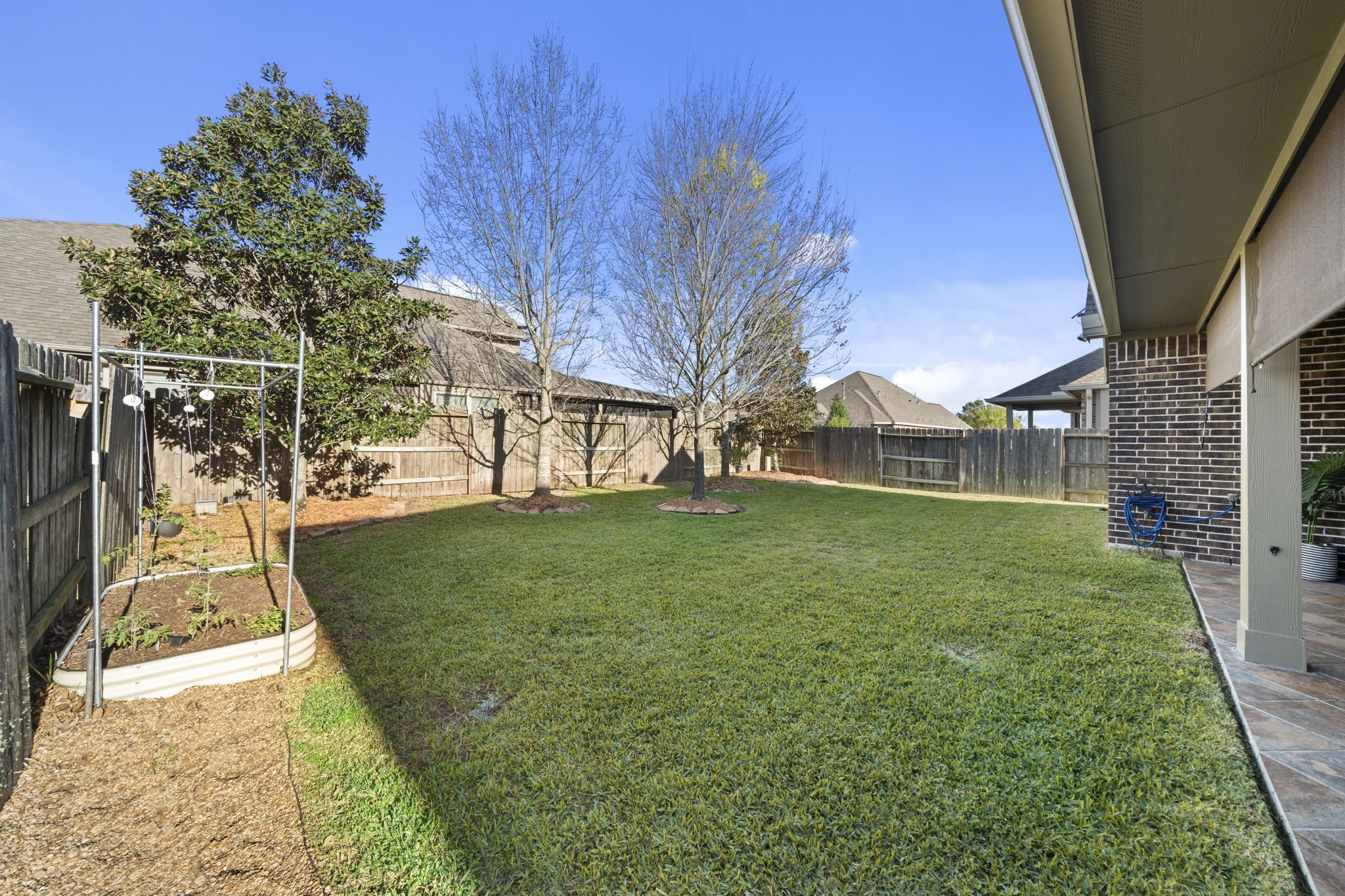 16731 Doubletree Ranch Drive Cypress, TX 77433 - Photo 32 of 44 Spacious backyard with a well-maintained lawn, mature Maple, Oak and Magnolia trees, and a garden bed.
