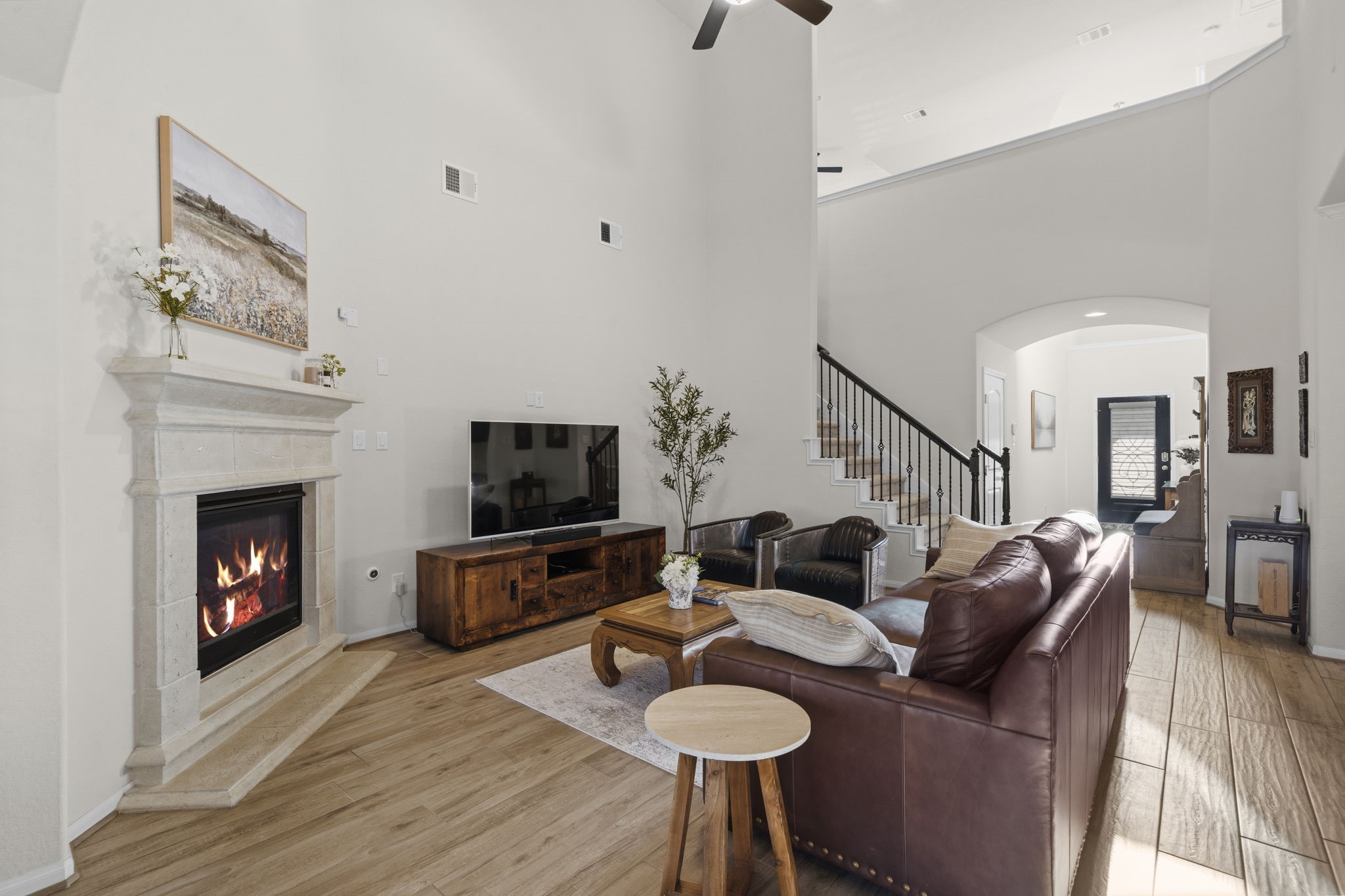 16731 Doubletree Ranch Drive Cypress, TX 77433 - Photo 7 of 44 This inviting living room features high ceilings with crown molding, a cozy fireplace, wood-look porcelain tile flooring and an open staircase with wrought iron rail.