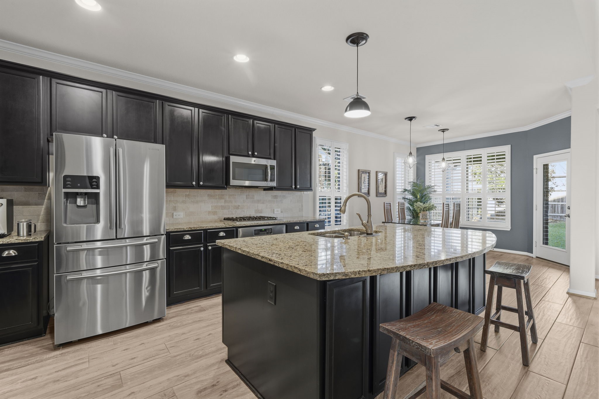 16731 Doubletree Ranch Drive Cypress, TX 77433 - Photo 9 of 44 The spacious kitchen features cabinets along the front of the island, high-end stainless steel appliances, and oversized granite countertops.