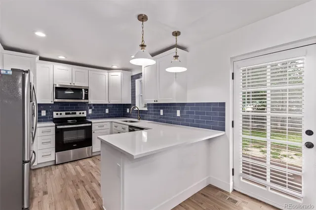 a kitchen with a sink appliances and cabinets