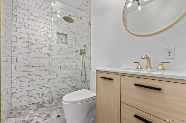 a bathroom with a sink a toilet and a mirror