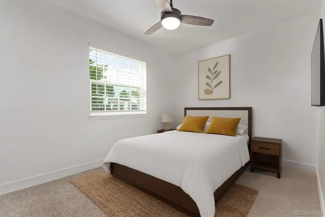 a bedroom with a bed lamp and a window