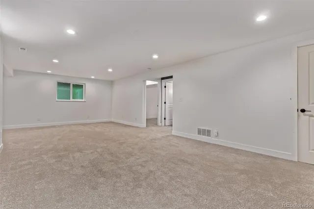 an empty room with a empty space and windows