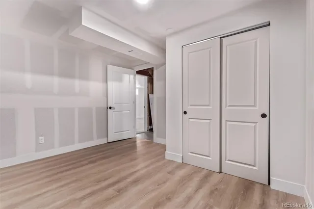 a view of an empty room and wooden floor