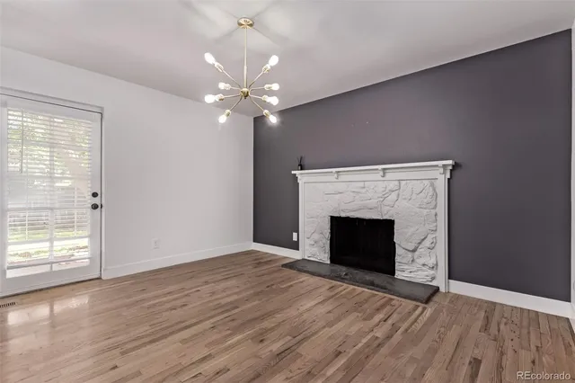 wooden floor fireplace and natural light in room