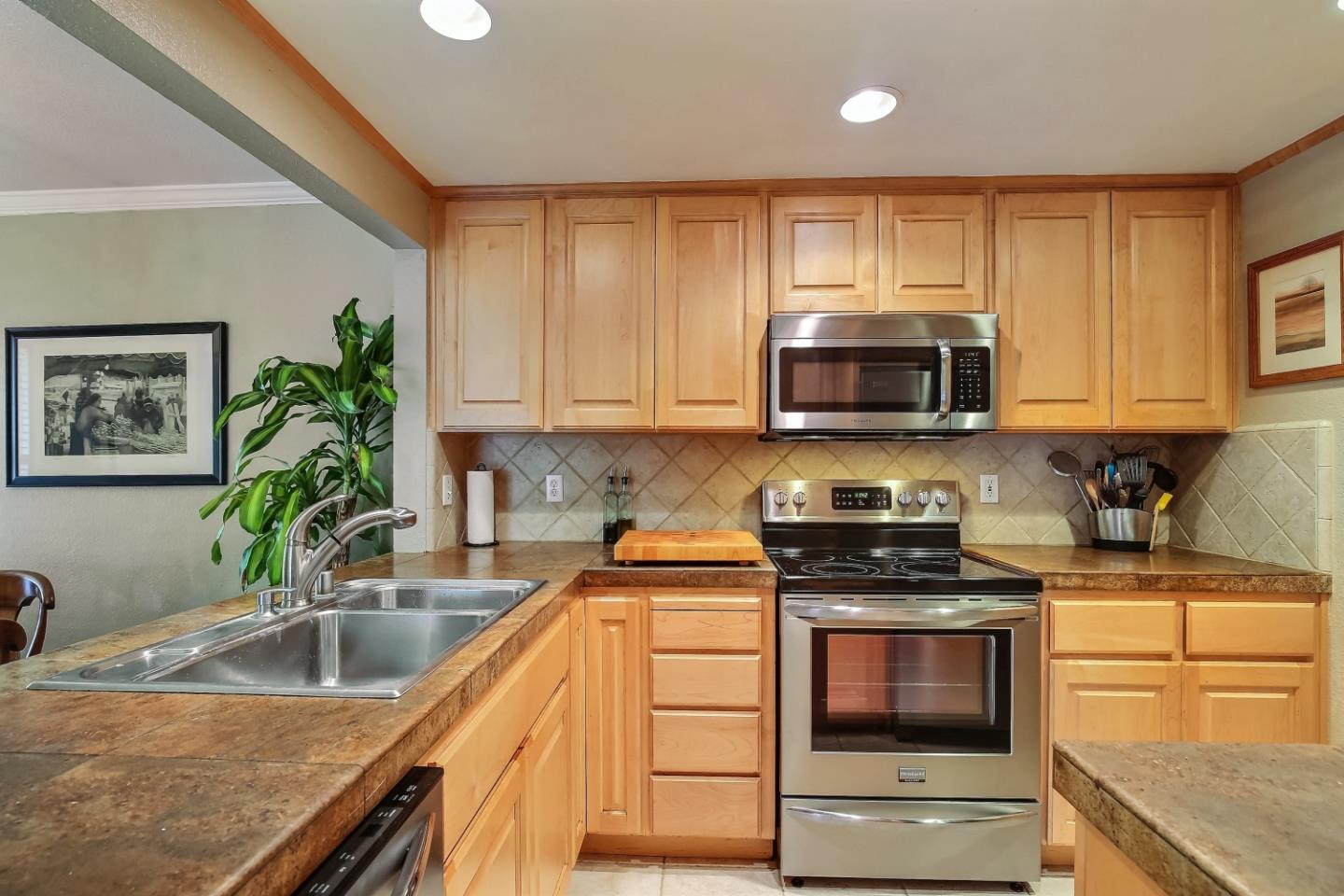 Braddock Court San Jose, CA 95125 - Photo 11 of 20 a kitchen with stainless steel appliances granite countertop a sink a stove top oven a counter space and cabinets