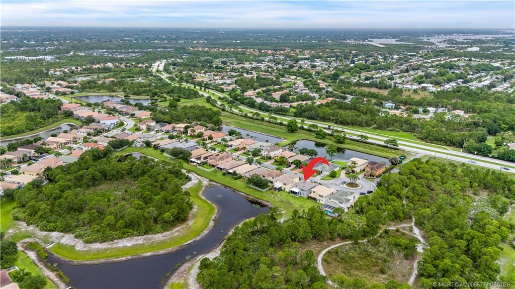 1268 Southeast Kirk Street Stuart, FL 34997 - Photo 57 of 63 an aerial view of residential houses with outdoor space and trees
