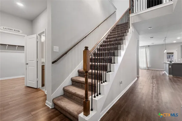 a view of entryway and hall with wooden floor
