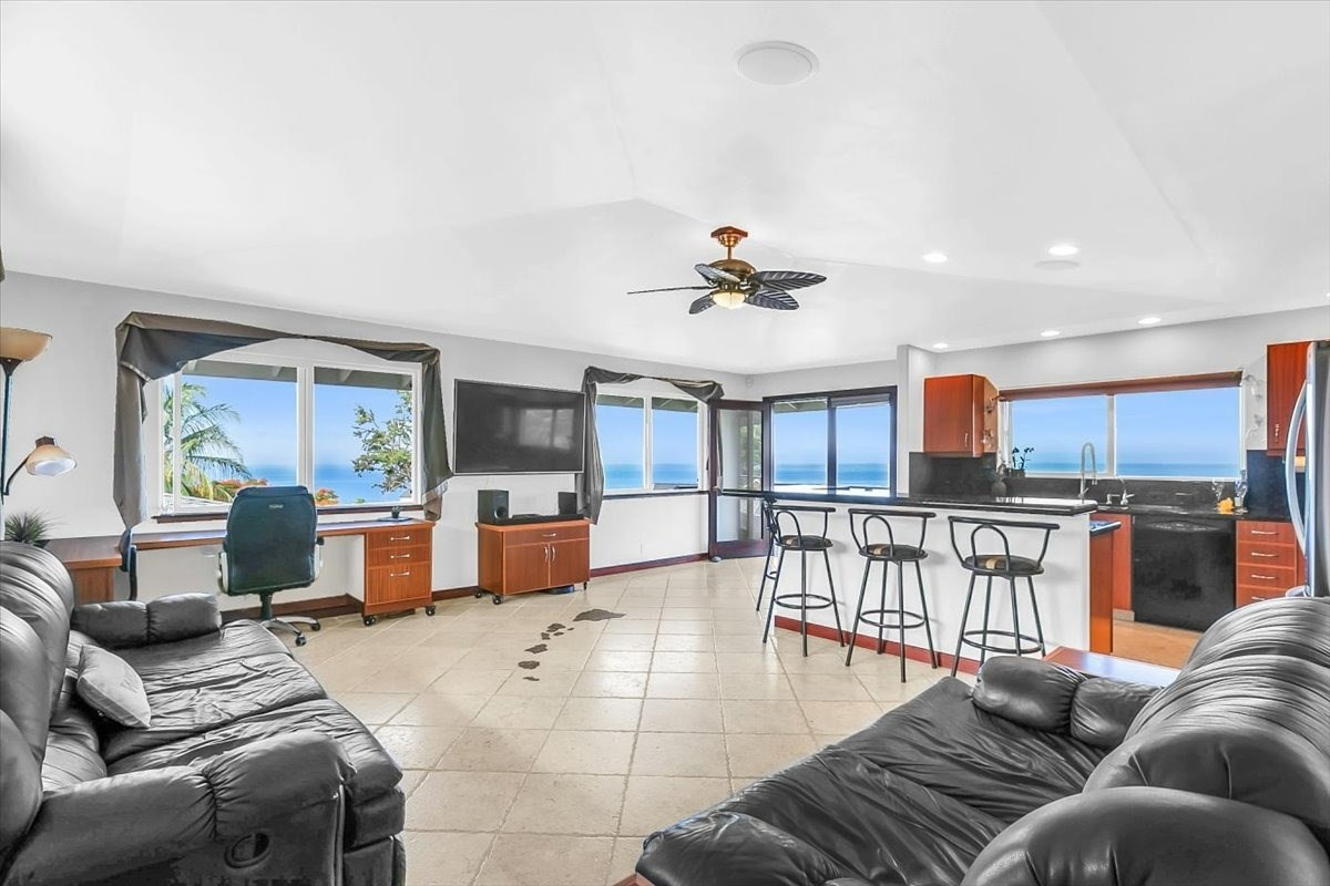 77-6410 Kepano Place - Spectacular ocean vies from every room. Quality craftsmanship and luxury finishes are found throughout the home.  An inset of the Hawaiian Islands hand cut from Italian basalt in the living room.