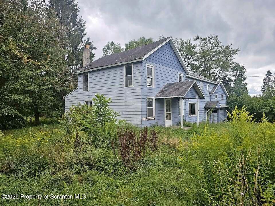 68 Oxbow Road Union Dale, PA 18470 - Photo 1 of 20 a view of a house with a small yard plants and large tree