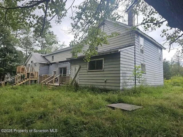 a view of a back yard of the house