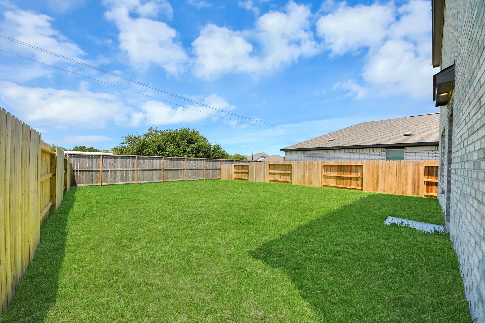 2931 Summer Breeze Way Angleton, TX 77515 - Photo 25 of 30 a view of a backyard with a garden