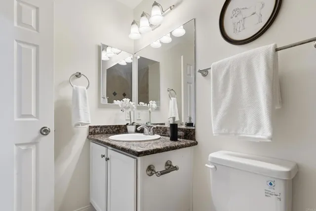 a bathroom with a sink vanity and a mirror