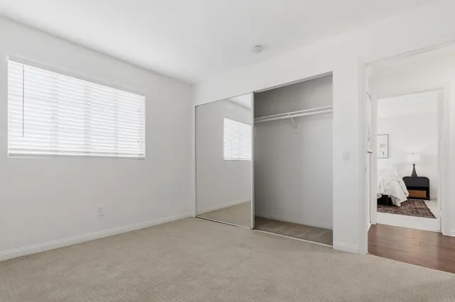 a view of empty room with windows and bathroom view