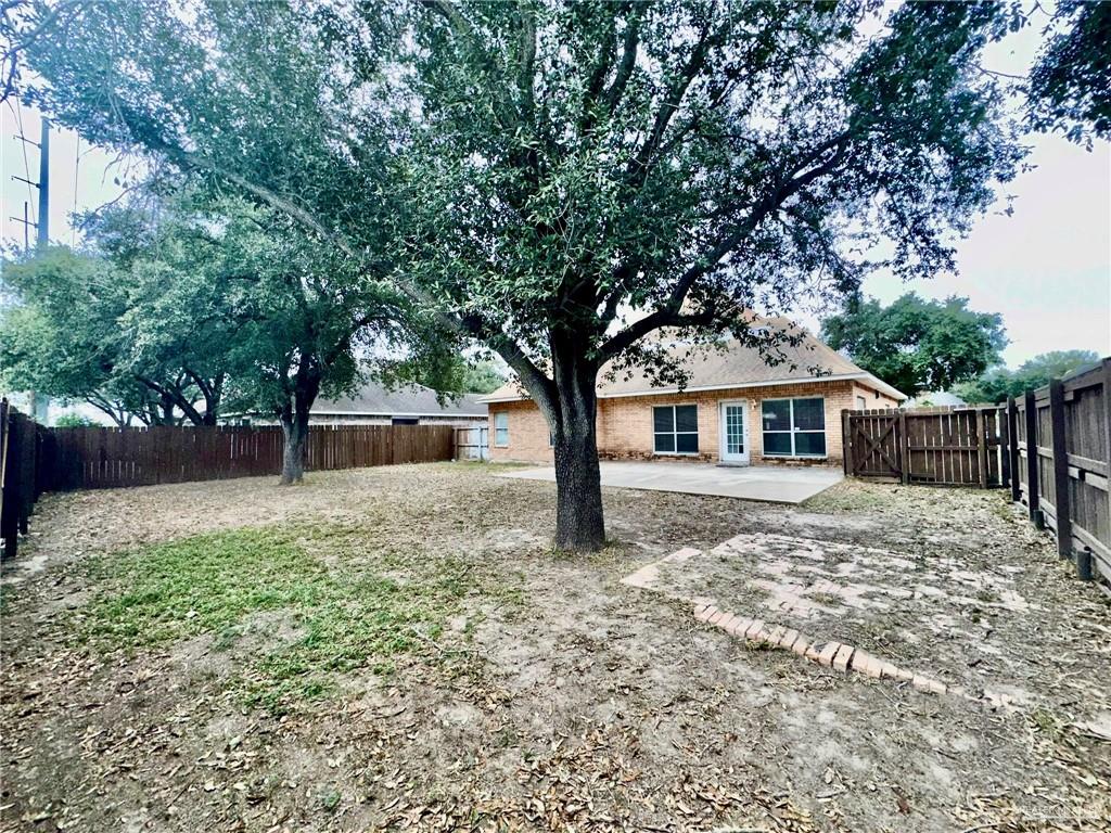 2109 Umar Avenue McAllen, TX 78504 - Photo 13 of 25 a white house that has a tree in front of it