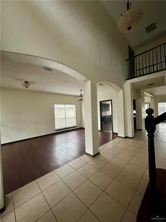 a view of a livingroom with wooden floor and staircase