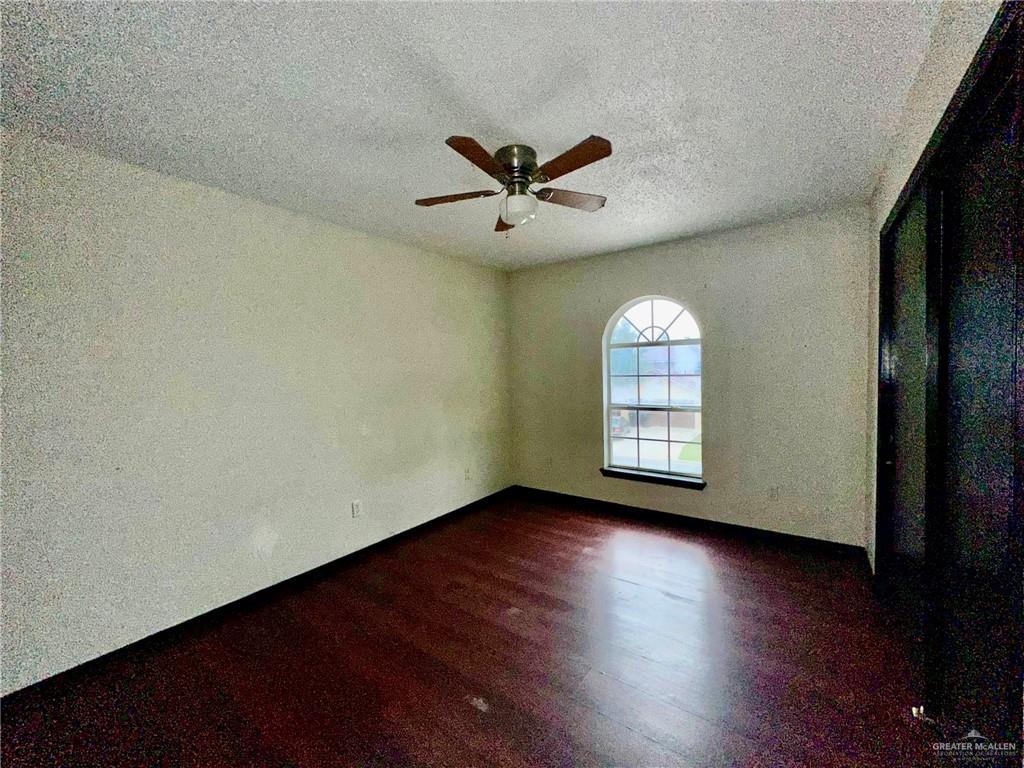 2109 Umar Avenue McAllen, TX 78504 - Photo 17 of 25 an empty room with wooden floor and windows