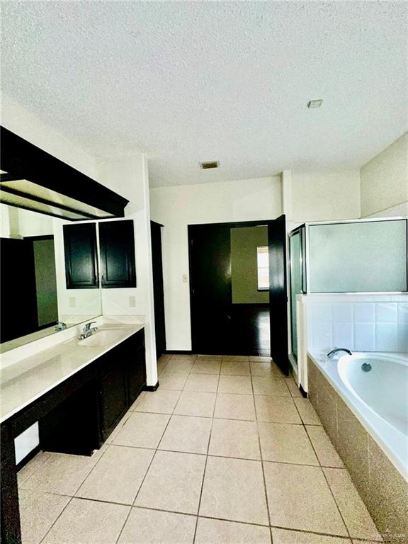 2109 Umar Avenue McAllen, TX 78504 - Photo 18 of 25 a bathroom with a bathtub and a double vanity sink