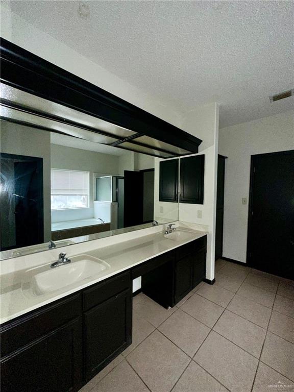 2109 Umar Avenue McAllen, TX 78504 - Photo 22 of 25 a bathroom with a double vanity sink a and mirror