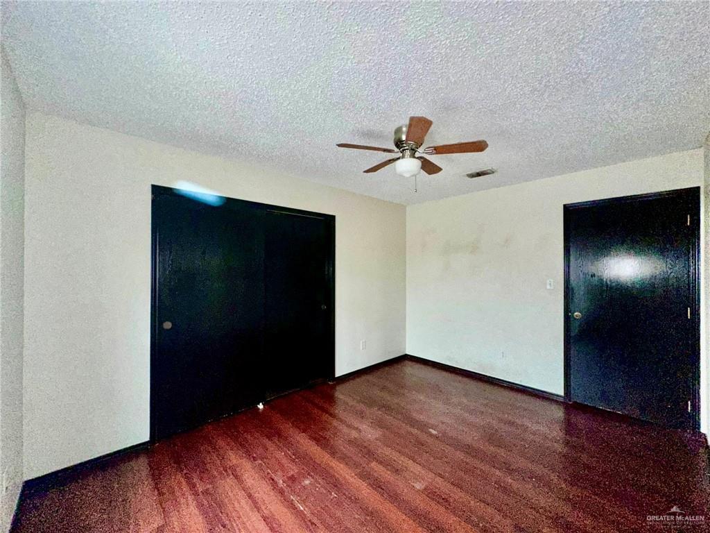 2109 Umar Avenue McAllen, TX 78504 - Photo 23 of 25 a view of a livingroom with a hardwood floor and a ceiling fan