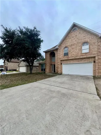 a front view of house with yard and trees