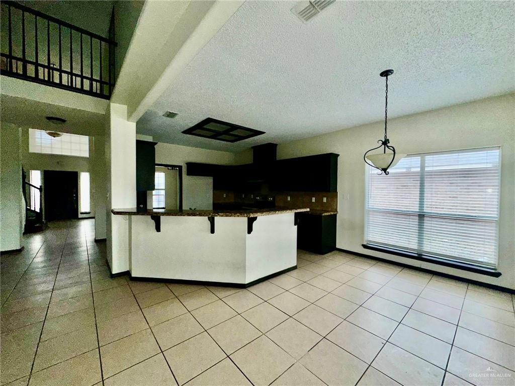 2109 Umar Avenue McAllen, TX 78504 - Photo 7 of 25 a kitchen with stainless steel appliances granite countertop a sink a counter top space and cabinets