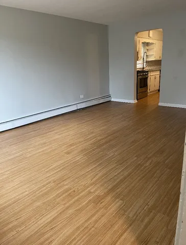 a view of a room with wooden floor