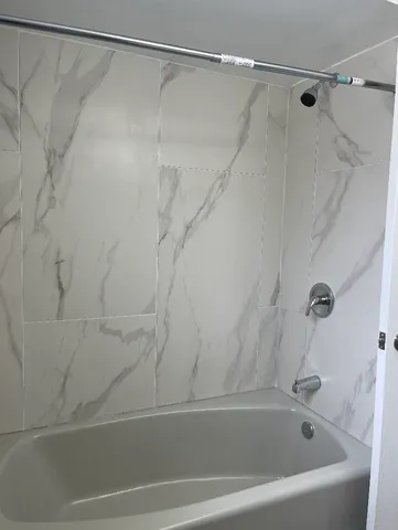 a bathroom with a shower and a shower