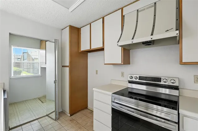 a kitchen with stainless steel appliances a stove and a microwave oven