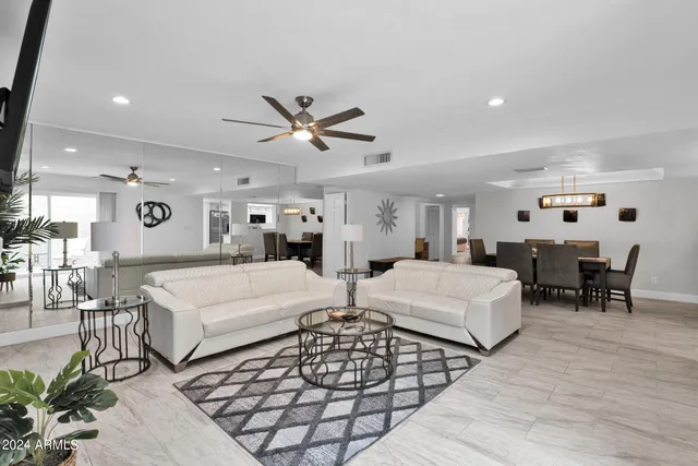 a very nice looking room with a large bed a couch and furniture