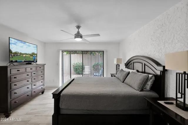 a bedroom with a bed and a flat screen tv