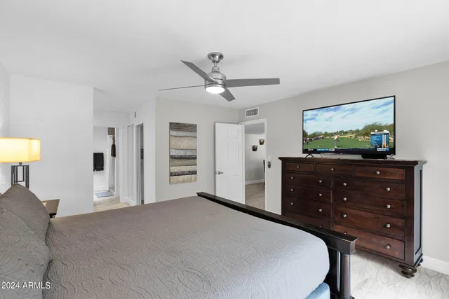 a bedroom with a bed and a dresser