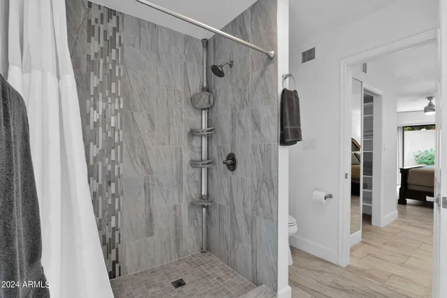 a bathroom with a shower and a sink