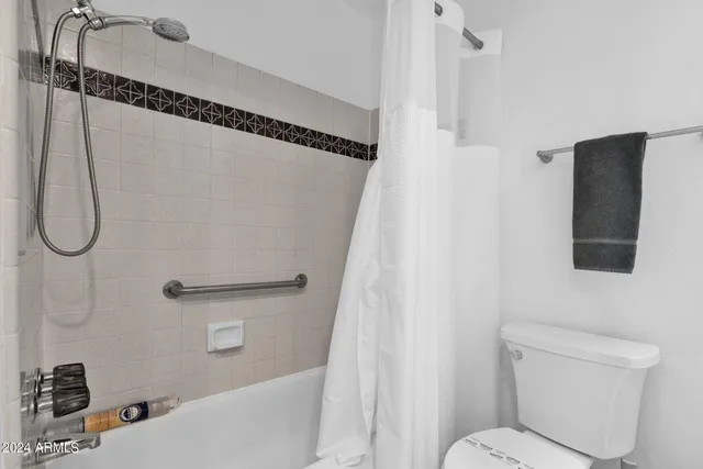 a bathroom with a toilet and a shower