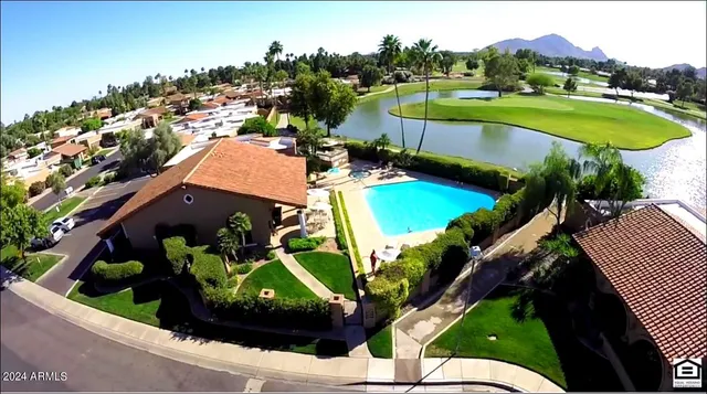 an aerial view of a house with a swimming pool