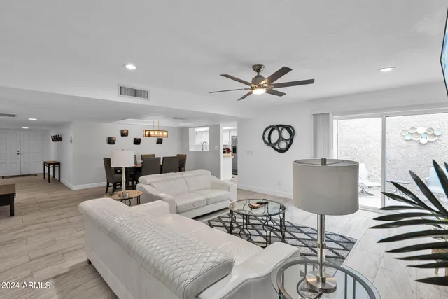 a living room with furniture a rug and a window