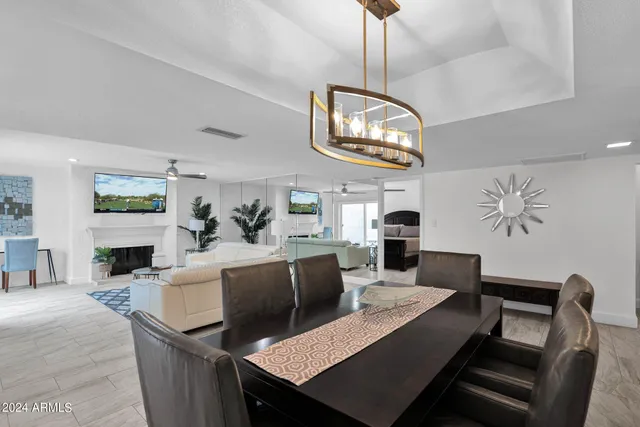 a view of a dining room with furniture and chandelier