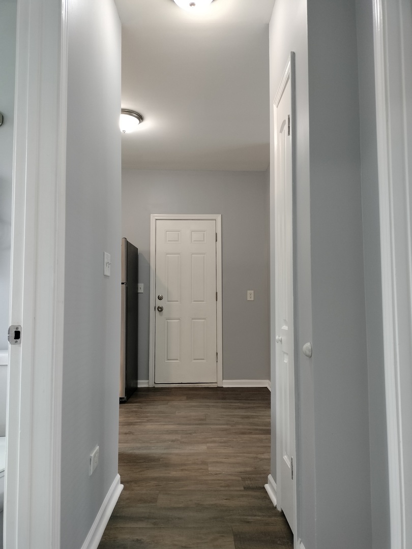 6601 South Green Street, Unit 8211 Chicago, IL 60621 - Photo 12 of 12 a view of a hallway with wooden floor