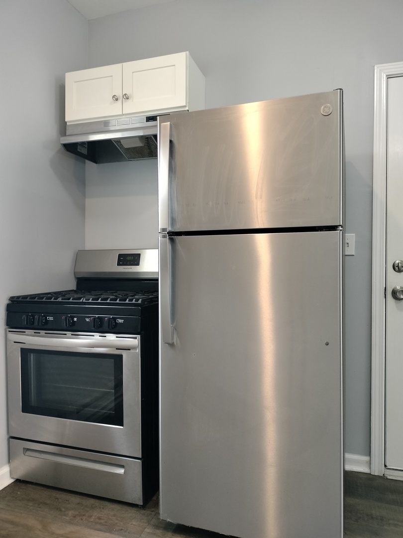 6601 South Green Street, Unit 8211 Chicago, IL 60621 - Photo 5 of 12 a stove top oven sitting inside of a kitchen