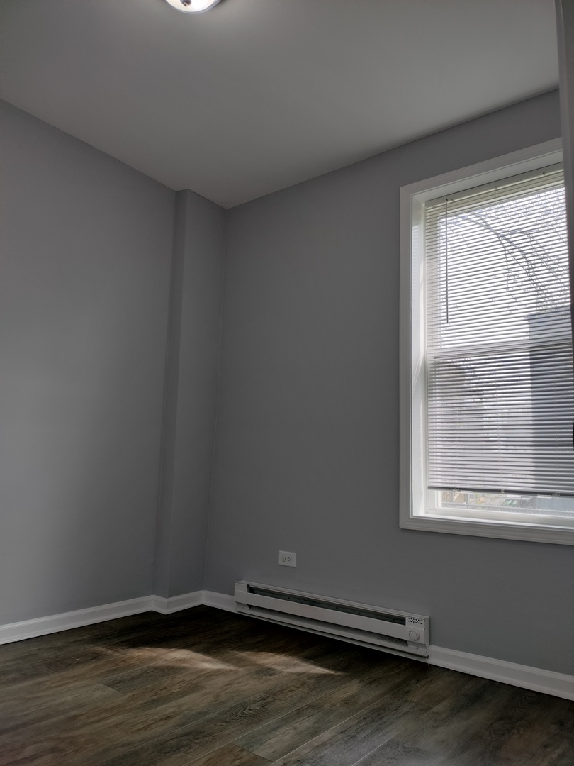 6601 South Green Street, Unit 8211 Chicago, IL 60621 - Photo 10 of 12 a view of a room with wooden floor and a window