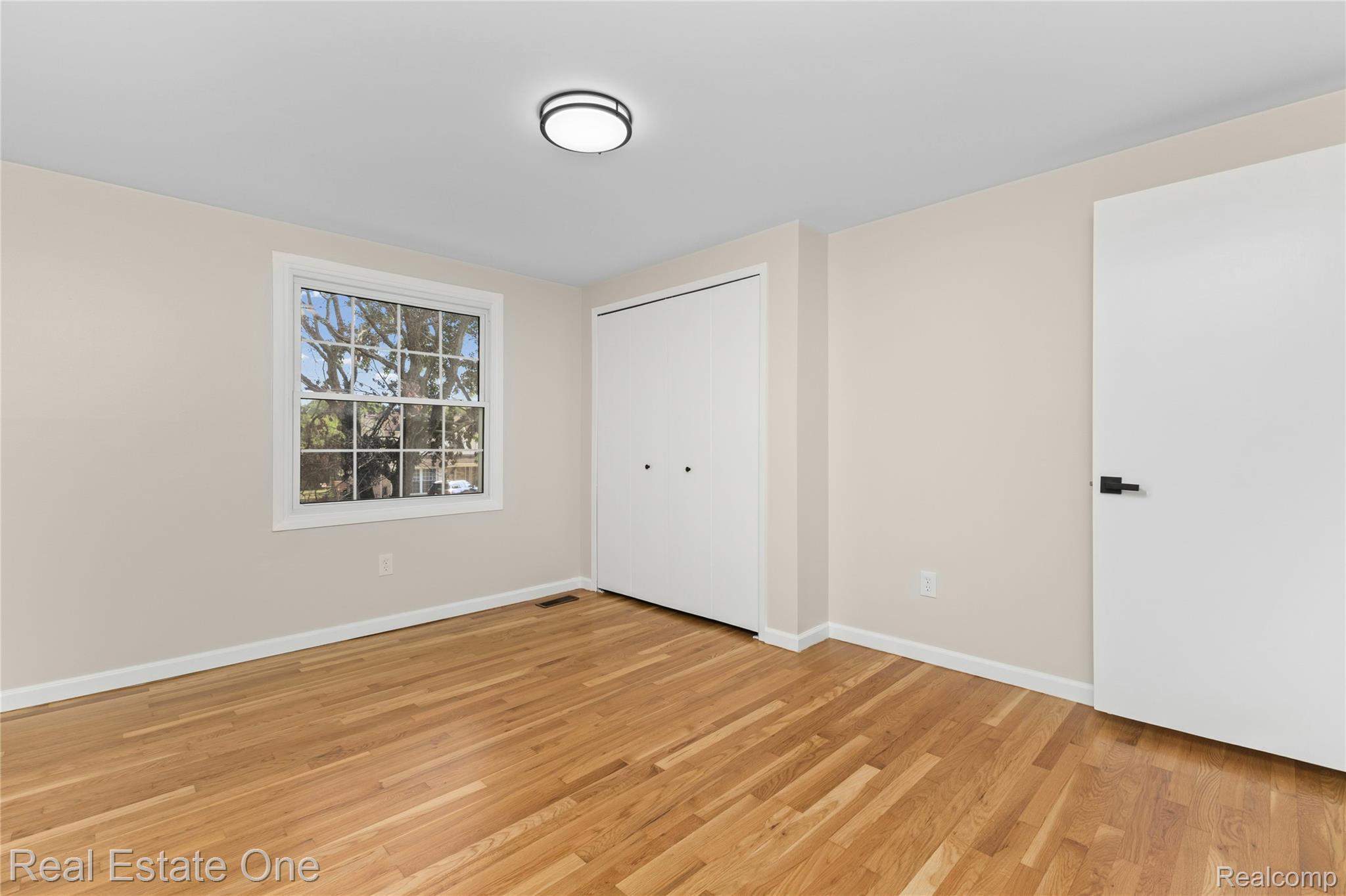 25695 Branchaster Road Farmington, MI 48336 - Photo 43 of 58 Hardwood flooring, white trim, recessed lighting, double-door closet, and modern door hardware