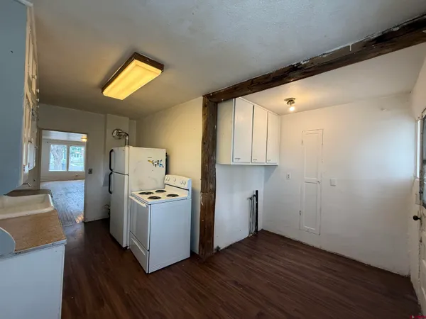 a view of a kitchen with wooden floor and a sink