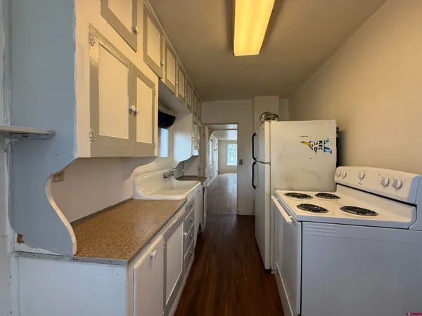 a kitchen that has a refrigerator and a stove