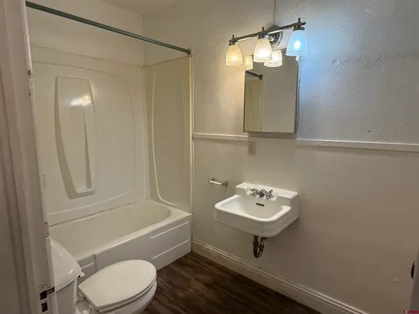 a bathroom with a toilet a sink and bathtub