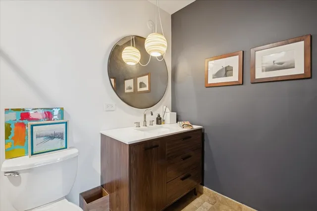 a bathroom with a toilet a sink and a mirror