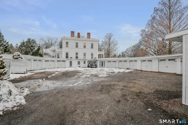 a view of white house with a yard and covered with snow