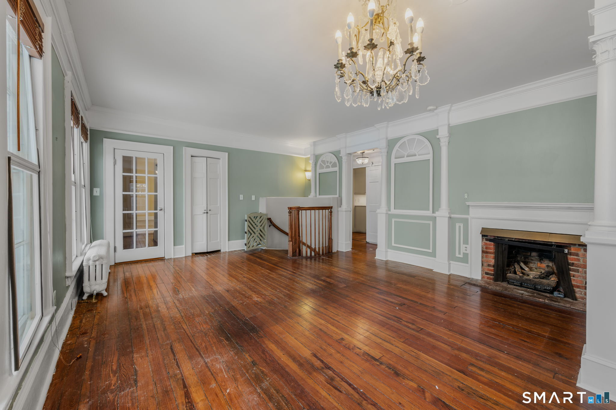 9 Lyme Street, Unit 2 Old Lyme, CT 06371 - Photo 17 of 29 a view of a livingroom with wooden floor and a fireplace