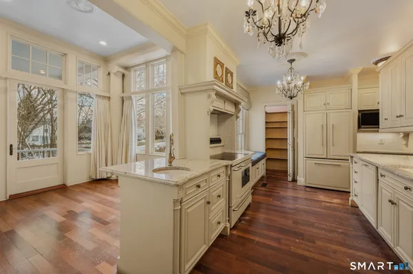 a large white kitchen with a large window