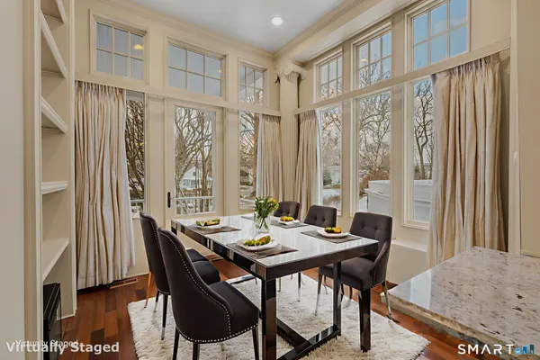 a view of a dining room with furniture window and wooden floor