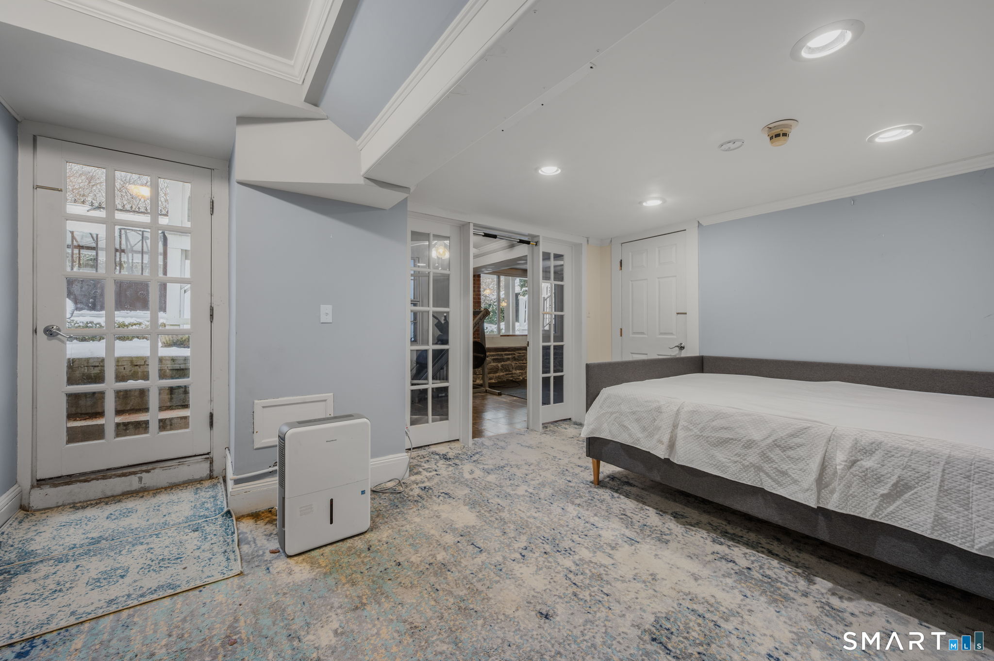 9 Lyme Street, Unit 2 Old Lyme, CT 06371 - Photo 23 of 29 a spacious bedroom with a bed and a table in it